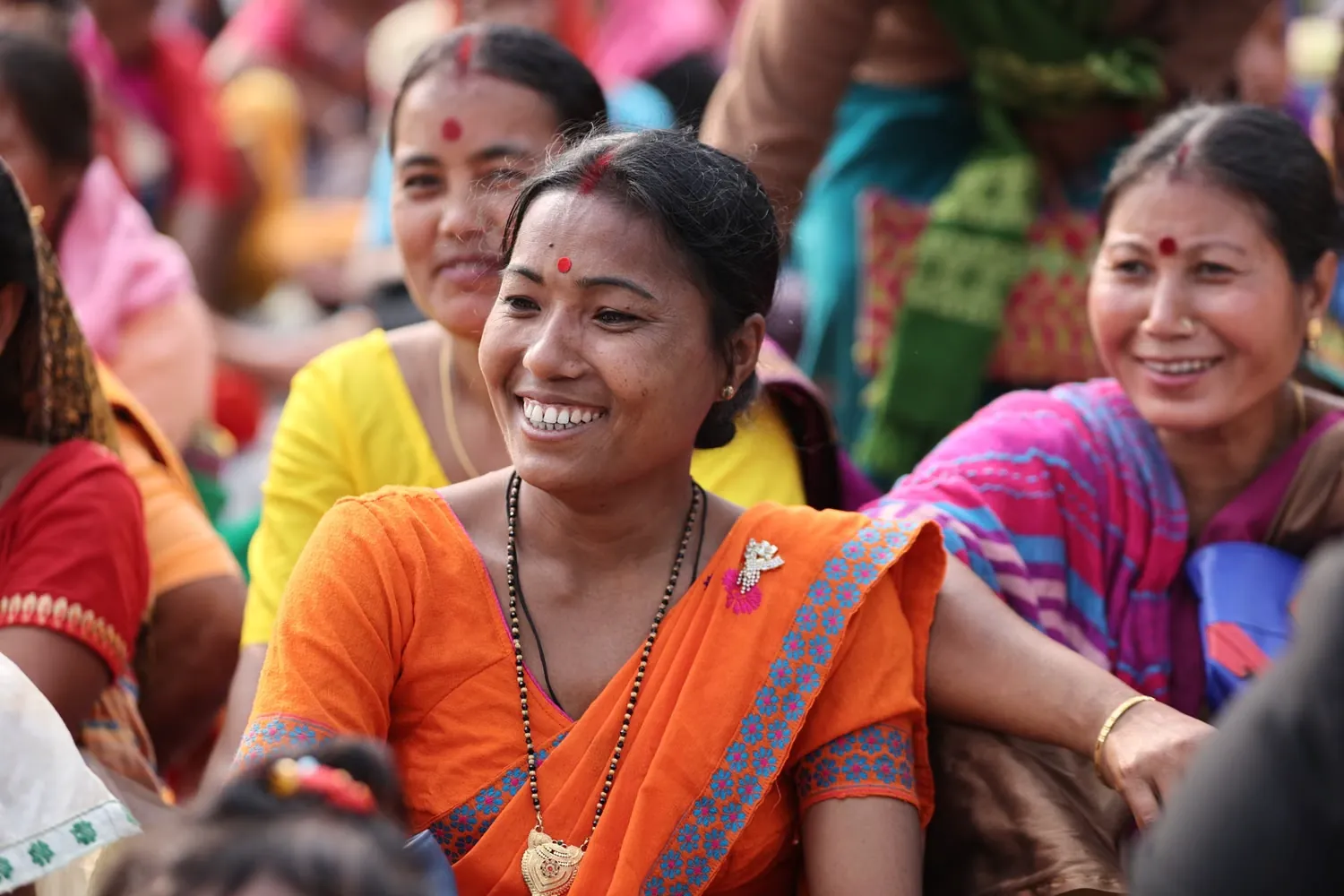 Women from an Indian community smiling together